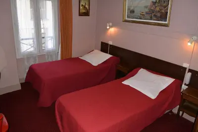 Un ou plusieurs lits dans un hébergement de l'établissement Hôtel Stanislas sans ascenseur