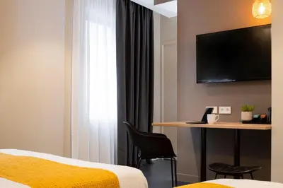 Un ou plusieurs lits dans un hébergement de l'établissement Aparthotel 37 Lodge Courbevoie Paris La Défense