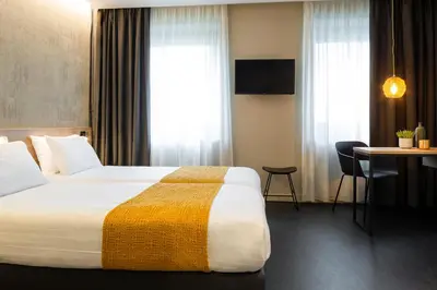 Un ou plusieurs lits dans un hébergement de l'établissement Aparthotel 37 Lodge Courbevoie Paris La Défense