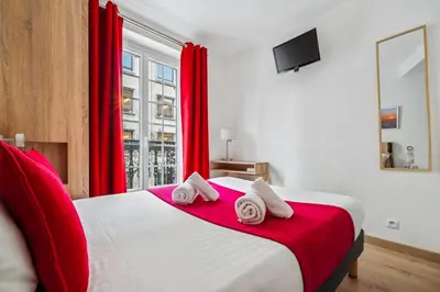 Un ou plusieurs lits dans un hébergement de l'établissement Hôtel Mazagran