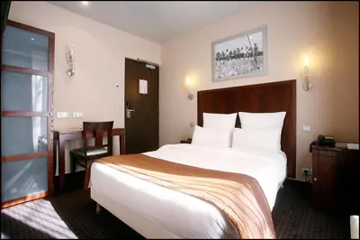 Un ou plusieurs lits dans un hébergement de l'établissement Grand Hotel Francais