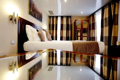 Un ou plusieurs lits dans un hébergement de l'établissement Grand Hotel Francais