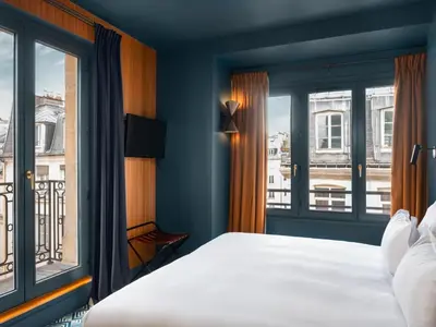 Un ou plusieurs lits dans un hébergement de l'établissement Hôtel Edgar & Achille