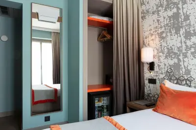 Un ou plusieurs lits dans un hébergement de l'établissement Hotel des Nations Saint Germain