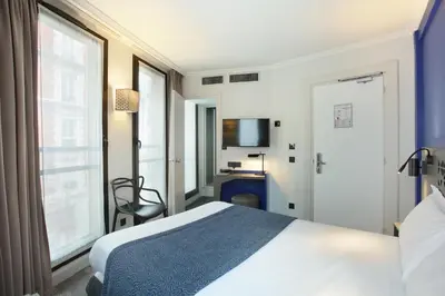 Un ou plusieurs lits dans un hébergement de l'établissement Hotel Eiffel Capitol