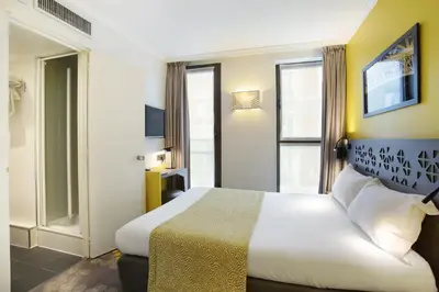 Un ou plusieurs lits dans un hébergement de l'établissement Hotel Eiffel Capitol