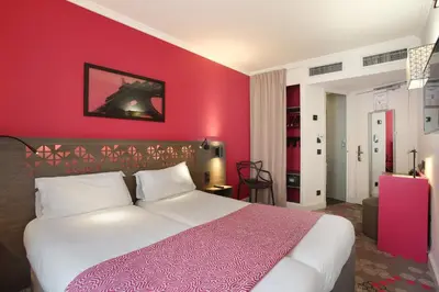Un ou plusieurs lits dans un hébergement de l'établissement Hotel Eiffel Capitol