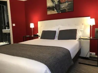 Un ou plusieurs lits dans un hébergement de l'établissement Hotel Dauphin