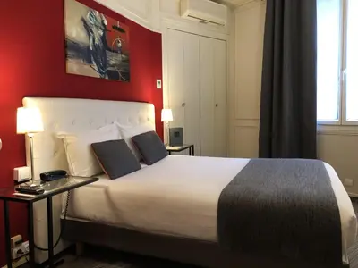 Un ou plusieurs lits dans un hébergement de l'établissement Hotel Dauphin