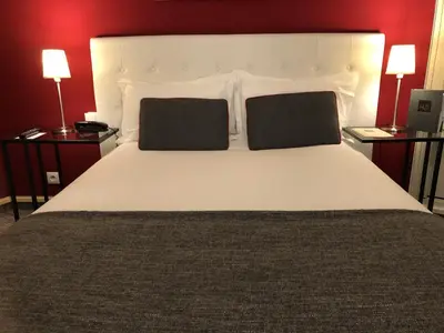Un ou plusieurs lits dans un hébergement de l'établissement Hotel Dauphin