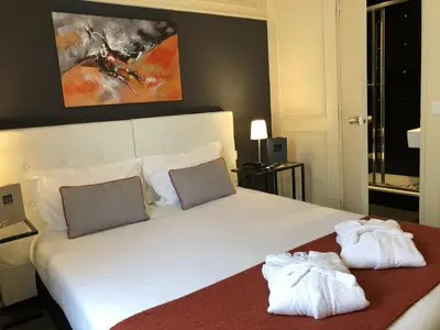 Un ou plusieurs lits dans un hébergement de l'établissement Hotel Dauphin