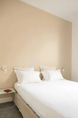 Un ou plusieurs lits dans un hébergement de l'établissement Hôtel Arvor Saint Georges