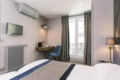 Un ou plusieurs lits dans un hébergement de l'établissement Hotel Saint Christophe