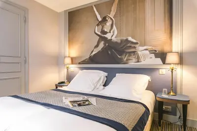 Un ou plusieurs lits dans un hébergement de l'établissement Hotel Saint Christophe