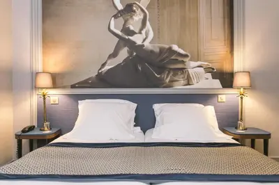 Un ou plusieurs lits dans un hébergement de l'établissement Hotel Saint Christophe