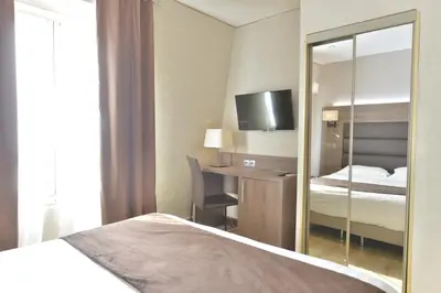 Un ou plusieurs lits dans un hébergement de l'établissement Hôtel Renoir Montparnasse