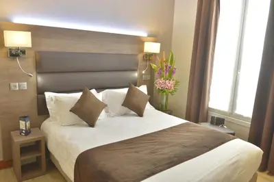 Un ou plusieurs lits dans un hébergement de l'établissement Hôtel Renoir Montparnasse