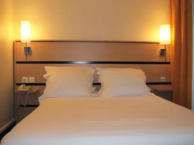 Un ou plusieurs lits dans un hébergement de l'établissement New Hotel Saint Lazare