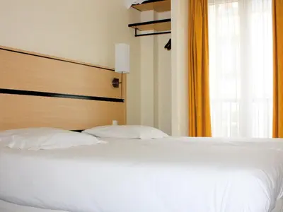 Un ou plusieurs lits dans un hébergement de l'établissement New Hotel Saint Lazare