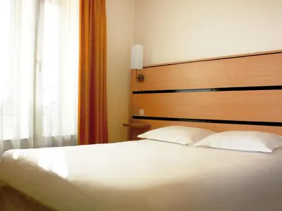 Un ou plusieurs lits dans un hébergement de l'établissement New Hotel Saint Lazare