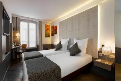 Un ou plusieurs lits dans un hébergement de l'établissement Contact Hôtel Alizé Montmartre