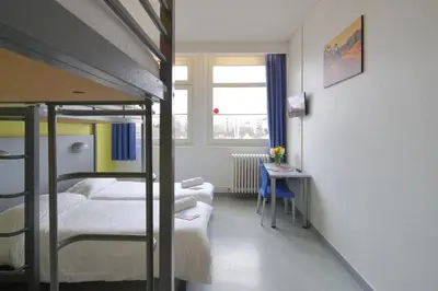 Un ou plusieurs lits dans un hébergement de l'établissement Hotel CIS Paris Maurice Ravel