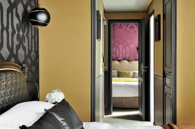 Un ou plusieurs lits dans un hébergement de l'établissement Hôtel Les Dames du Panthéon