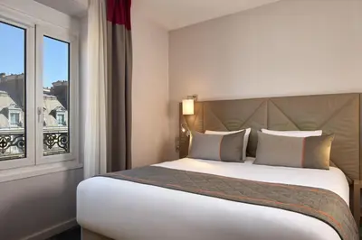 Un ou plusieurs lits dans un hébergement de l'établissement Timhotel Opera Madeleine