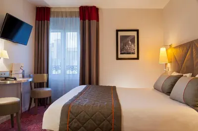 Un ou plusieurs lits dans un hébergement de l'établissement Timhotel Opera Madeleine