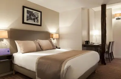 Un ou plusieurs lits dans un hébergement de l'établissement Timhotel Opera Madeleine