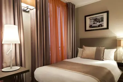 Un ou plusieurs lits dans un hébergement de l'établissement Timhotel Opera Madeleine
