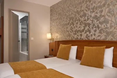 Un ou plusieurs lits dans un hébergement de l'établissement Timhotel Opera Madeleine