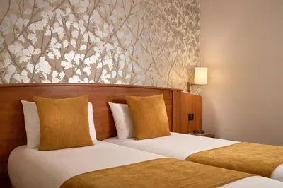 Un ou plusieurs lits dans un hébergement de l'établissement Timhotel Opera Madeleine