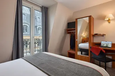 Un ou plusieurs lits dans un hébergement de l'établissement Timhotel Palais Royal