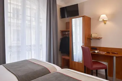 Un ou plusieurs lits dans un hébergement de l'établissement Timhotel Palais Royal