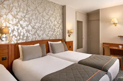 Un ou plusieurs lits dans un hébergement de l'établissement Timhotel Paris Gare Montparnasse