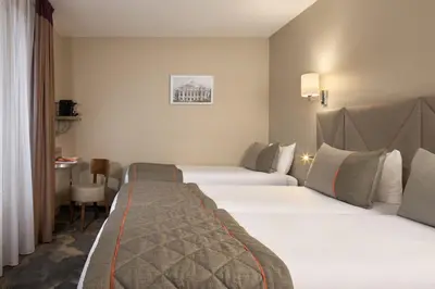 Un ou plusieurs lits dans un hébergement de l'établissement Timhotel Paris Gare Montparnasse