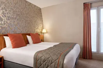 Un ou plusieurs lits dans un hébergement de l'établissement Timhotel Paris Gare Montparnasse