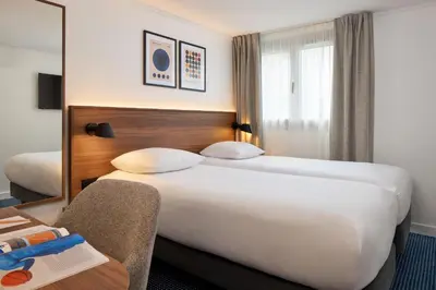 Un ou plusieurs lits dans un hébergement de l'établissement Timhotel Nation