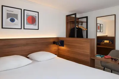 Un ou plusieurs lits dans un hébergement de l'établissement Timhotel Nation