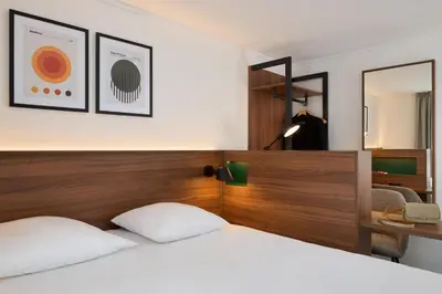 Un ou plusieurs lits dans un hébergement de l'établissement Timhotel Nation