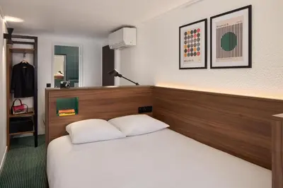 Un ou plusieurs lits dans un hébergement de l'établissement Timhotel Nation