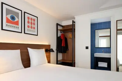 Un ou plusieurs lits dans un hébergement de l'établissement Timhotel Nation