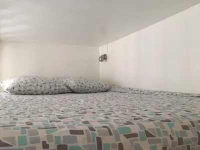 Un ou plusieurs lits dans un hébergement de l'établissement Maisonnette studio sur cour