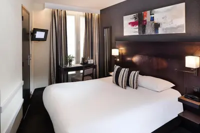 Un ou plusieurs lits dans un hébergement de l'établissement Hôtel Albert 1er Paris Lafayette