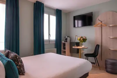 Un ou plusieurs lits dans un hébergement de l'établissement Hotel France Albion