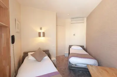 Un ou plusieurs lits dans un hébergement de l'établissement Hotel France Albion