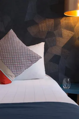 Un ou plusieurs lits dans un hébergement de l'établissement Hotel France Albion