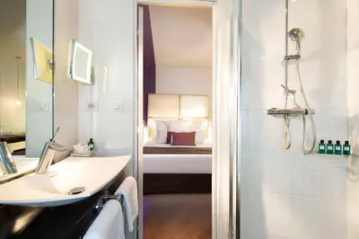 Un ou plusieurs lits dans un hébergement de l'établissement Grand Hotel Saint Michel