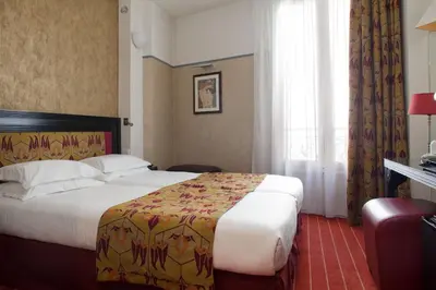 Un ou plusieurs lits dans un hébergement de l'établissement Hotel Eiffel Seine